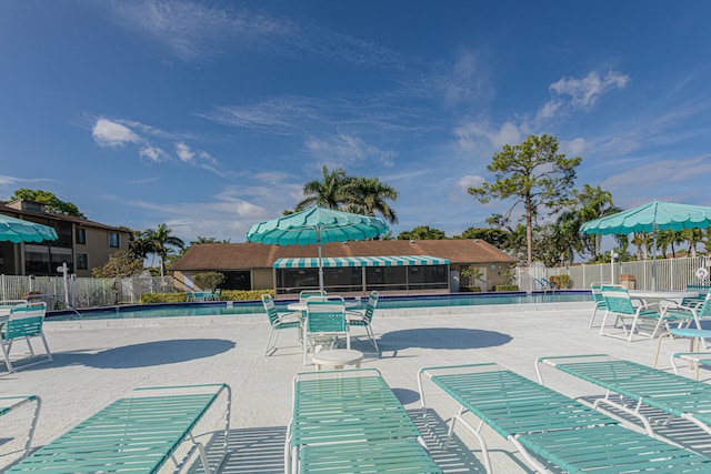 community pool featuring a patio area and fence