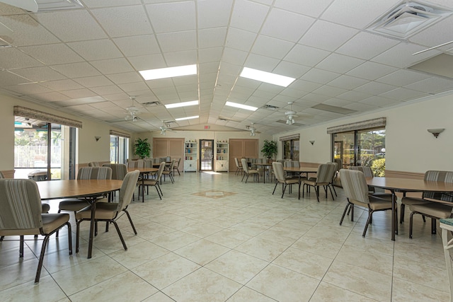 dining room with a paneled ceiling, visible vents, lofted ceiling, and light tile patterned flooring