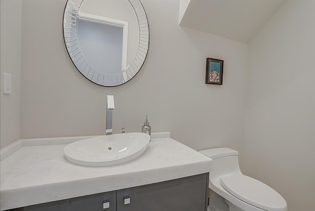 bathroom with toilet and vanity