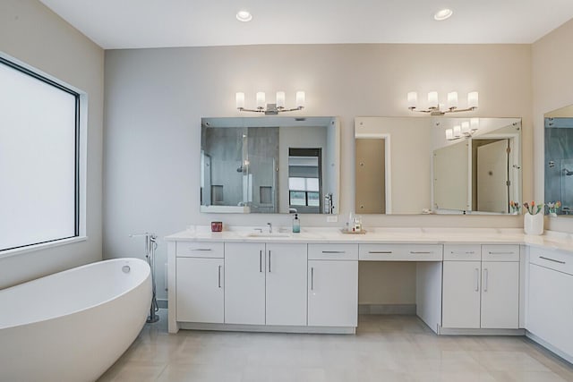 bathroom featuring vanity and independent shower and bath