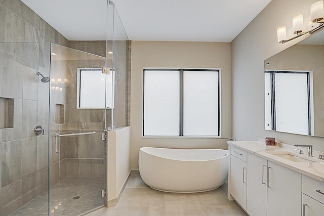 bathroom with plenty of natural light, vanity, and independent shower and bath