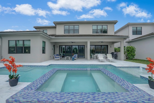 back of house with ceiling fan, a swimming pool with hot tub, an outdoor hangout area, and a patio