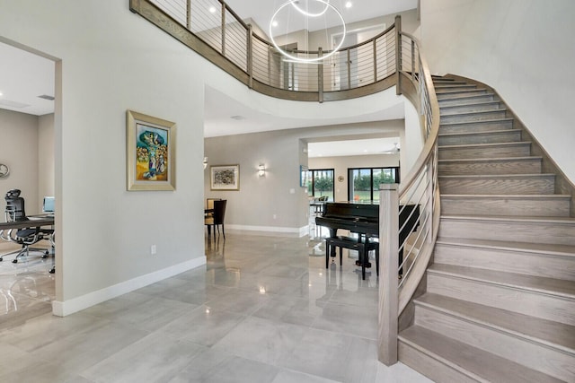 foyer entrance with a high ceiling and a chandelier