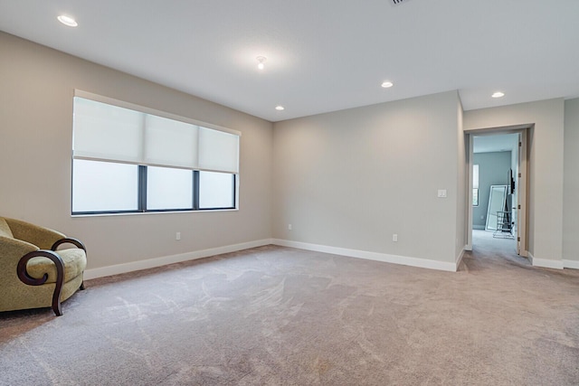 unfurnished room featuring light carpet