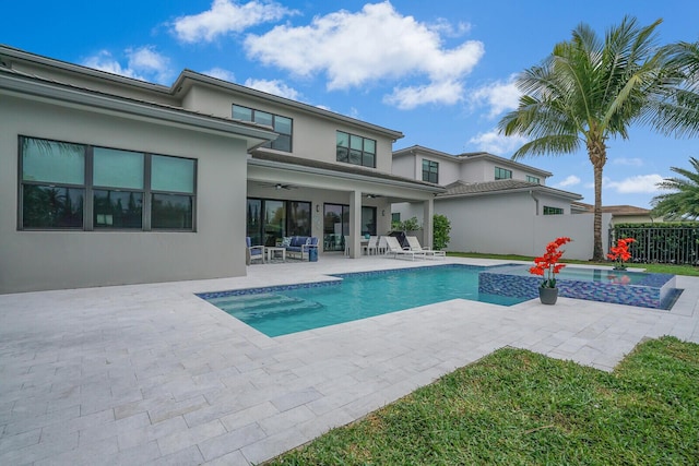 exterior space featuring ceiling fan, a patio area, and an in ground hot tub