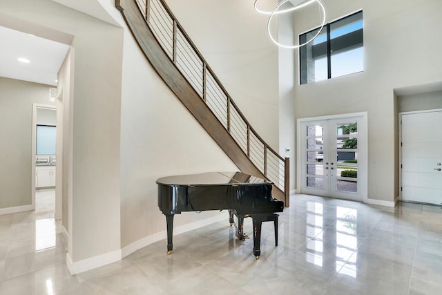 interior space featuring french doors and a towering ceiling