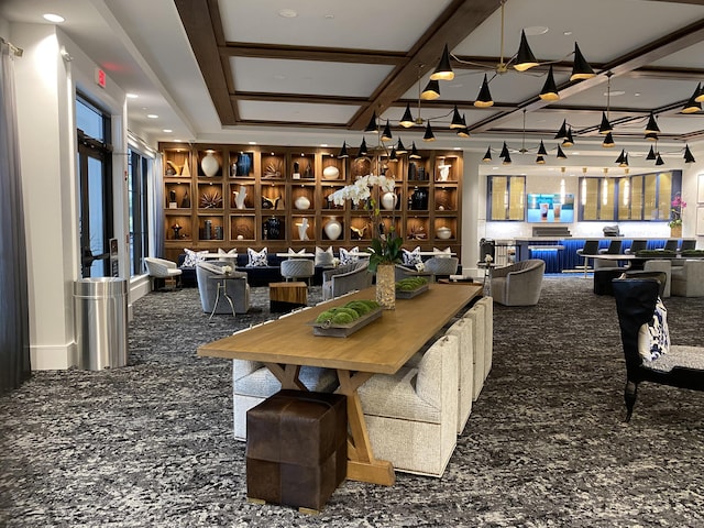 dining area featuring a wealth of natural light and coffered ceiling