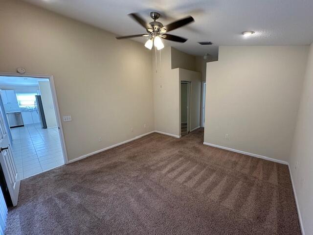 carpeted empty room with ceiling fan