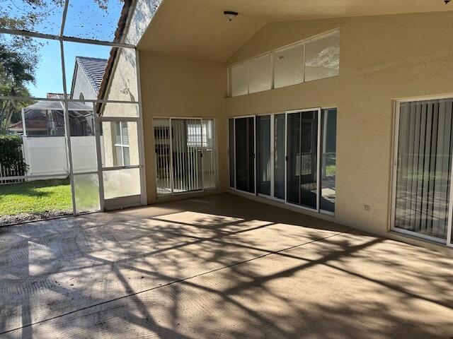 view of patio featuring glass enclosure