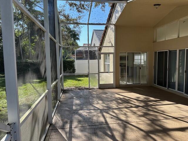 unfurnished sunroom featuring vaulted ceiling