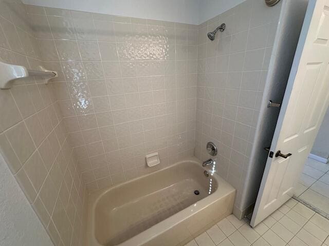 bathroom with tile patterned flooring and tiled shower / bath combo