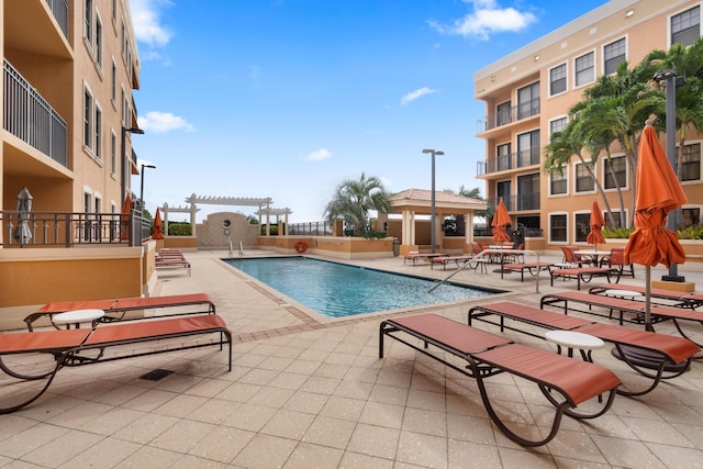 view of pool with a patio area and a pergola