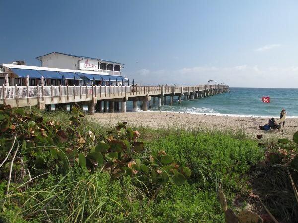 dock area with a water view and a view of the beach