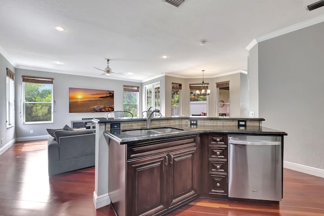 kitchen with dishwasher, a wealth of natural light, sink, and dark stone counters