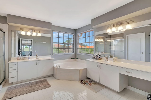 bathroom with shower with separate bathtub, vanity, and tile patterned floors