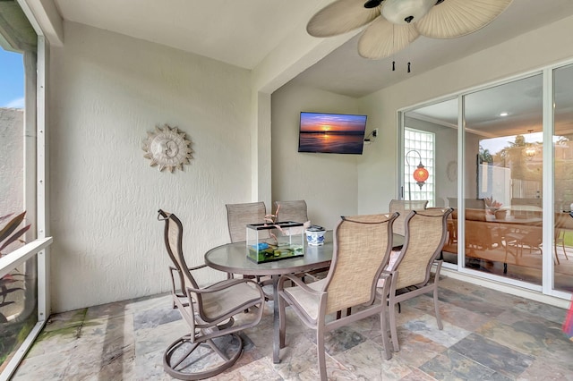 sunroom featuring ceiling fan