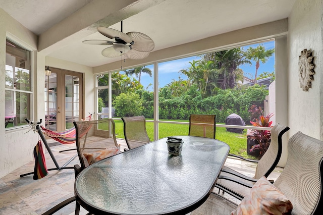 sunroom with french doors, plenty of natural light, and ceiling fan