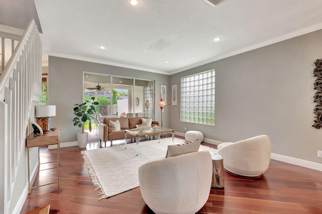 living area featuring ceiling fan, ornamental molding, and dark wood-type flooring