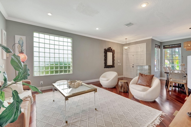 living room featuring hardwood / wood-style floors, plenty of natural light, and ornamental molding