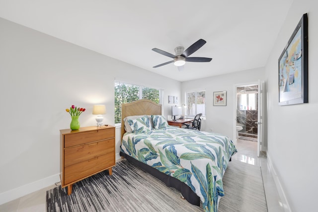 tiled bedroom with ensuite bath and ceiling fan