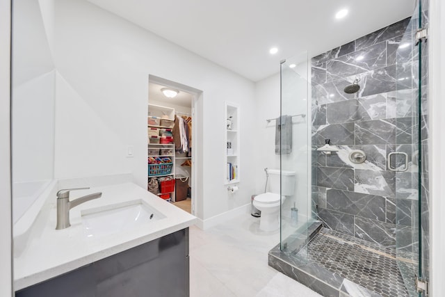 bathroom featuring vanity, an enclosed shower, and toilet