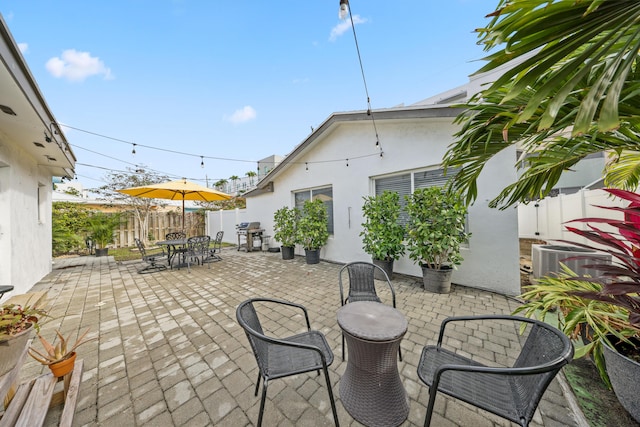 view of patio / terrace featuring central AC unit and a grill