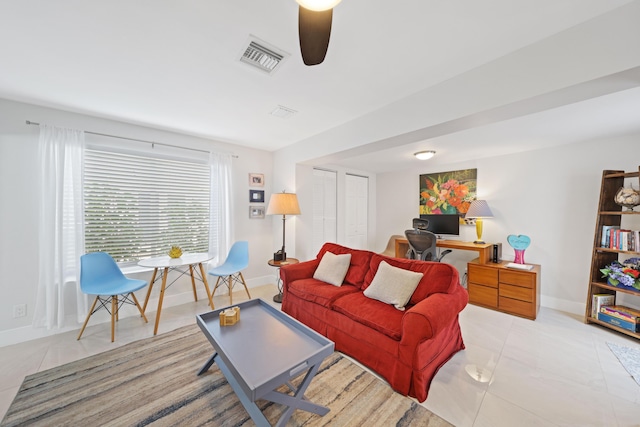 living room featuring ceiling fan and light tile patterned flooring