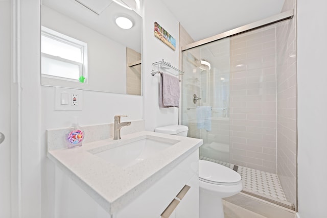 bathroom with vanity, toilet, and an enclosed shower