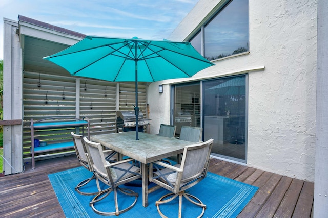 wooden deck featuring a grill