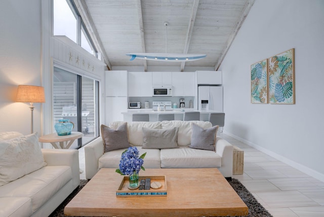 living room with beamed ceiling, high vaulted ceiling, wooden ceiling, and light tile patterned floors