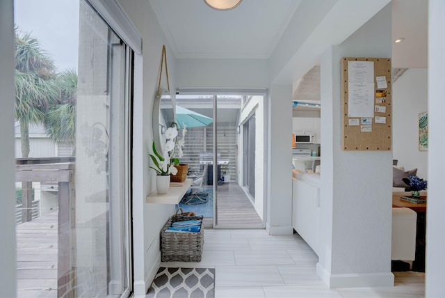 hall featuring crown molding and a wealth of natural light