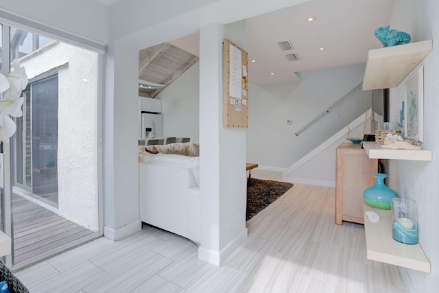 bathroom featuring beamed ceiling and hardwood / wood-style flooring