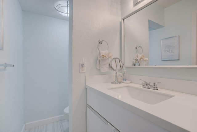 bathroom with vanity and toilet