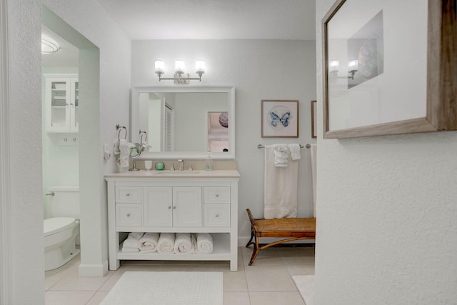 bathroom with tile patterned flooring, vanity, and toilet