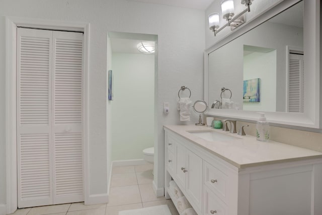 bathroom with tile patterned floors, vanity, and toilet