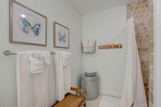 bathroom with tile patterned flooring and walk in shower