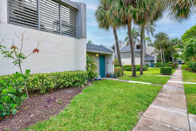 entrance to property with a lawn