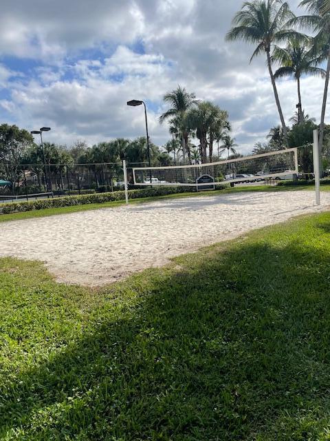 view of home's community featuring volleyball court and a yard