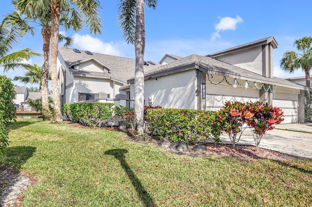 view of front facade with a front yard and a garage