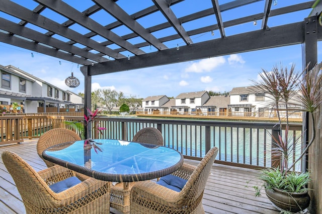 wooden deck featuring a water view and a pergola