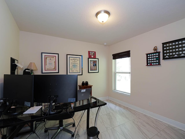 home office featuring a textured ceiling