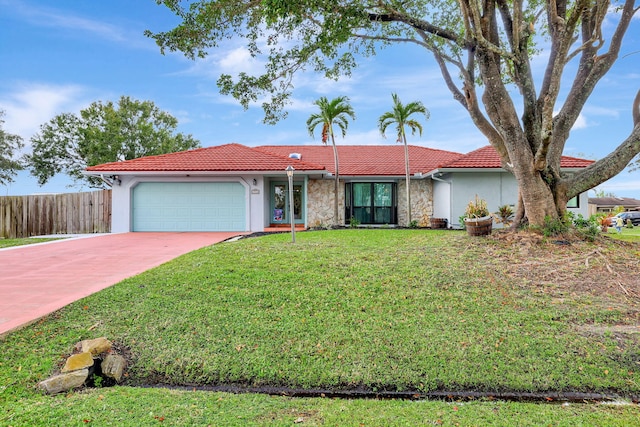 ranch-style home featuring a front lawn and a garage