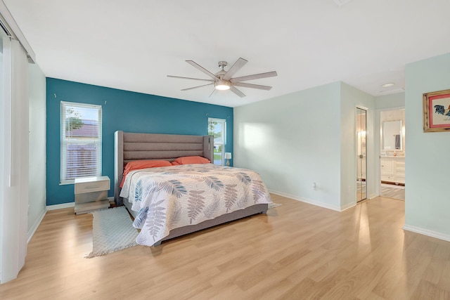 bedroom with light wood-type flooring, multiple windows, and ceiling fan