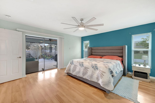 bedroom with access to exterior, light hardwood / wood-style floors, and ceiling fan