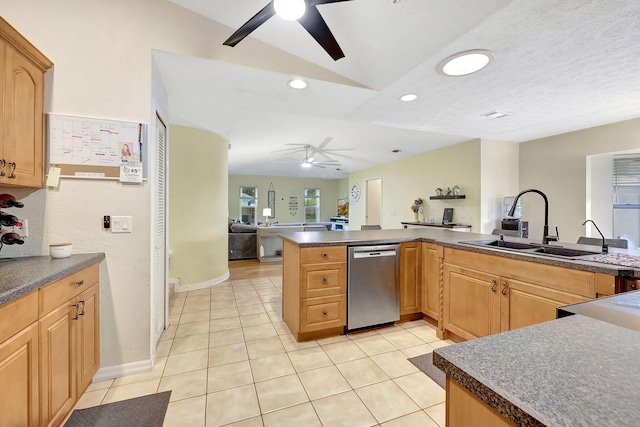 kitchen featuring sink, stainless steel dishwasher, light brown cabinetry, light tile patterned flooring, and kitchen peninsula