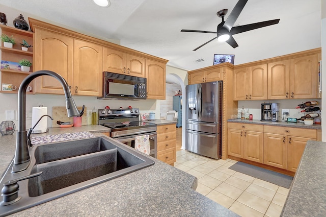 kitchen featuring ceiling fan, sink, light tile patterned floors, and stainless steel appliances