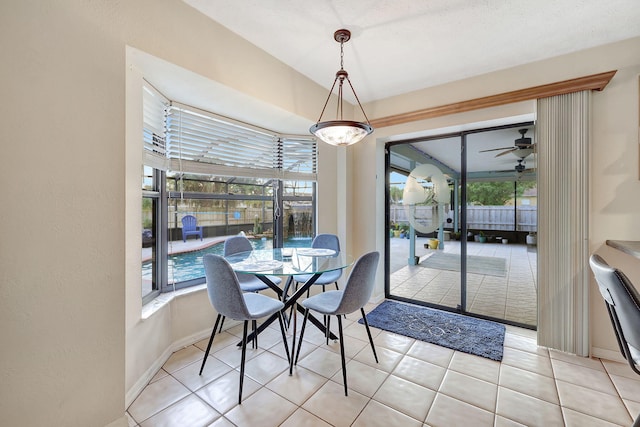 tiled dining area with ceiling fan