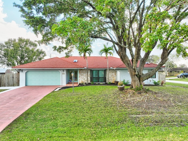 ranch-style home featuring a garage and a front lawn