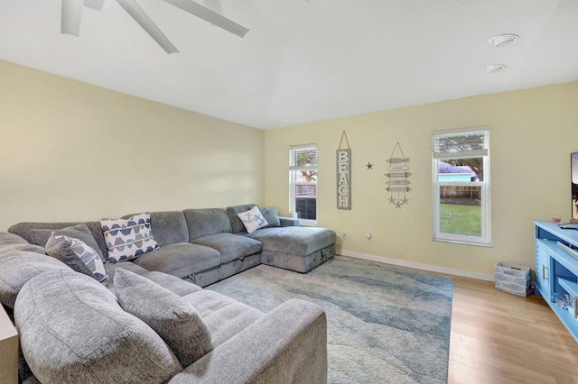 living room featuring ceiling fan and light hardwood / wood-style floors