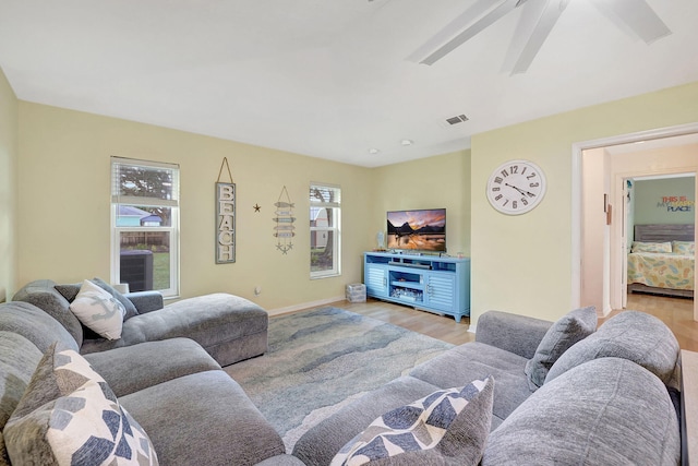 living room with light hardwood / wood-style floors and ceiling fan